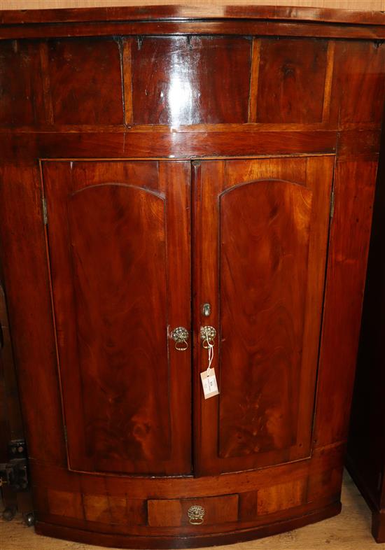 A Regency mahogany bowfront hanging corner cupboard W.90cm